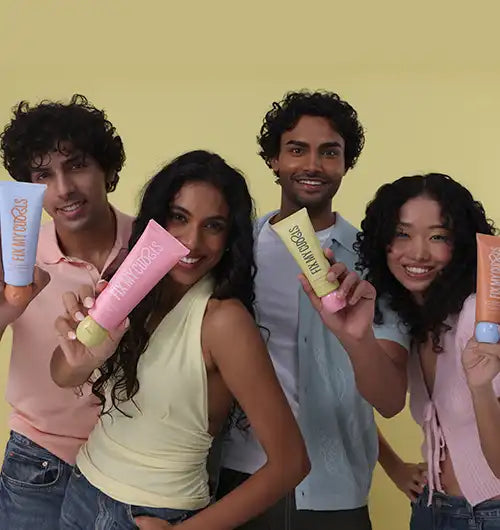 Models holding Fix My Curls product tubes