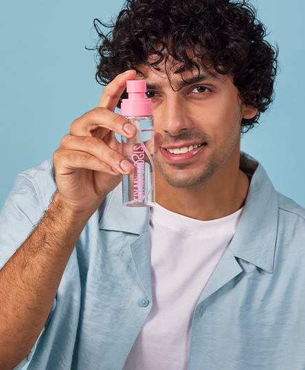 Man holding Fix My Curls' Floral Bouquet with a blue background