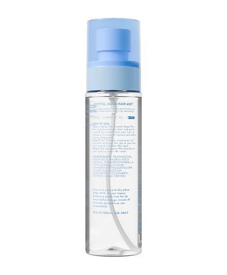 The backside of Crystal Aqua Hair Mist bottle with blue cap on a white background