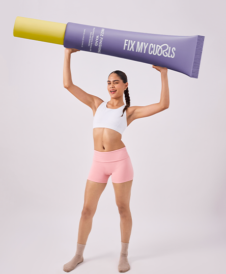 The model is posing with Frizz Finishing Wand of  Fix My Curls in a white background