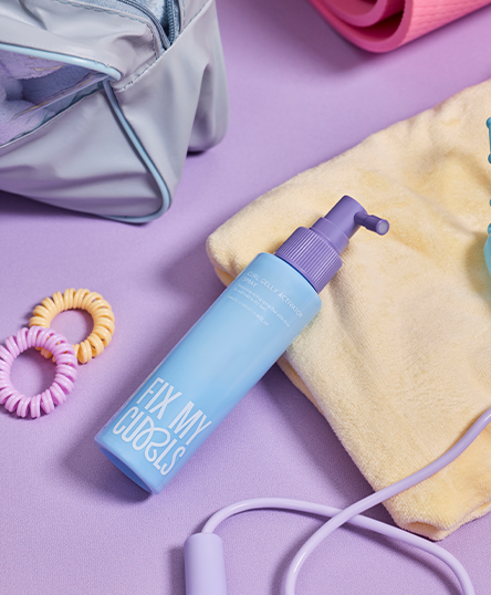 Fix My Curls'  Curl Gelly Activator spray takes center stage against a beautifully styled backdrop